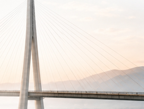 A modern bridge tower at dawn.